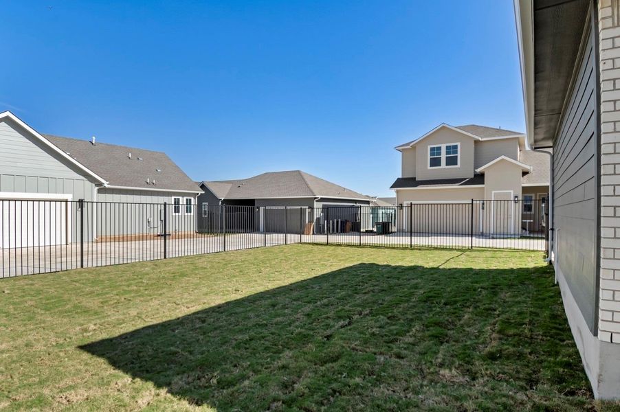 Fenced backyard featuring a garage Fenced backyard featuring a garage