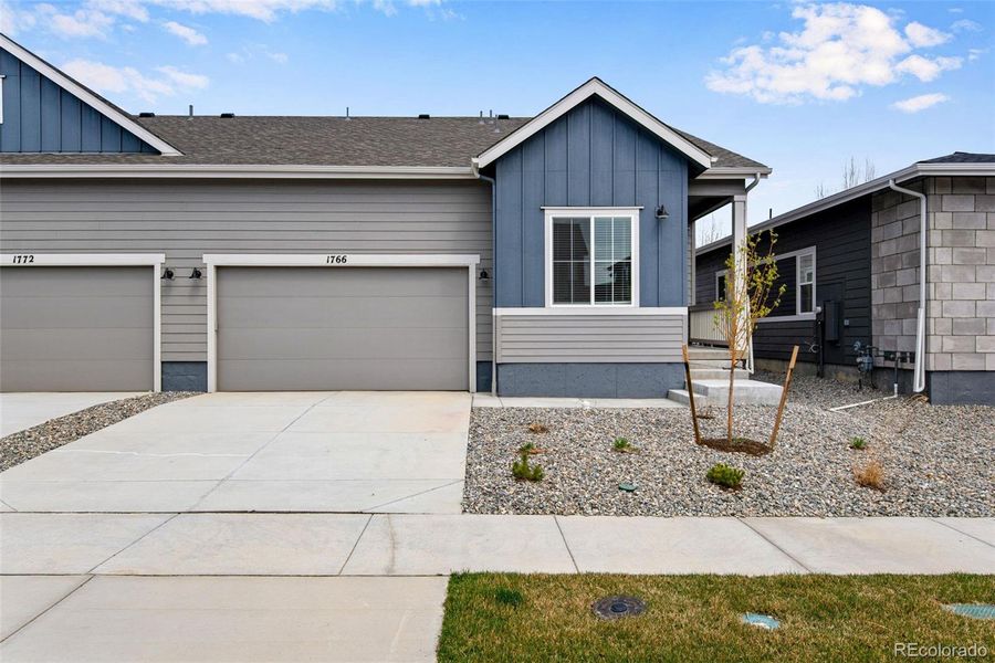 Front exterior of a new home in , Berthoud, CO, highlighting curb appeal (Image 1).