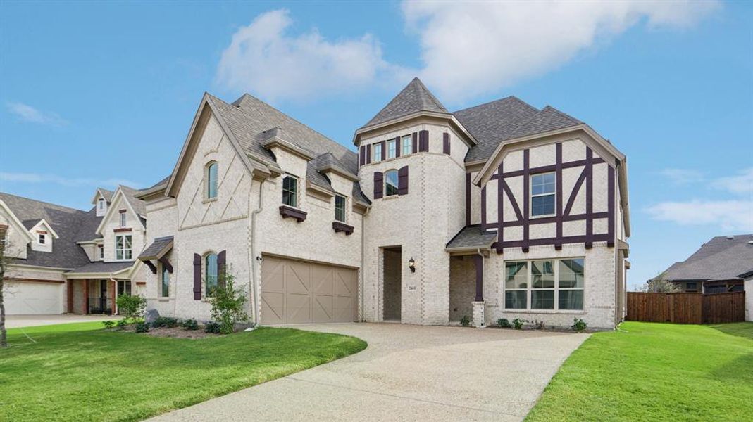 Tudor house featuring brick siding, driveway, and a shingled roof Tudor house featuring brick siding, driveway, and a shingled roof