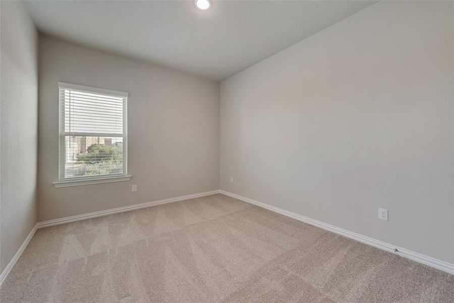 Unfurnished room featuring light carpet