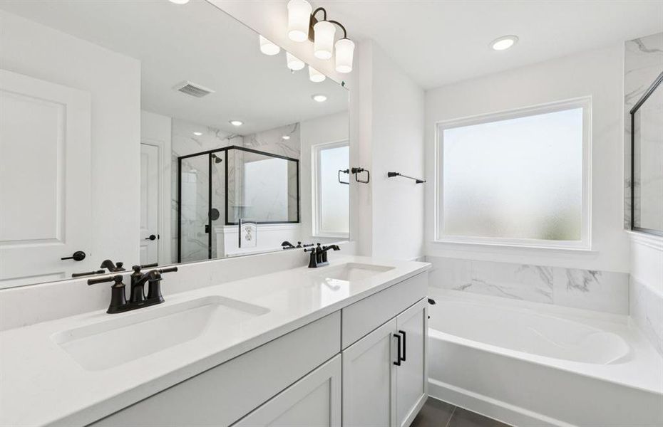 Modern owner's bath with dual vanities and a spacious shower   *Real home pictured