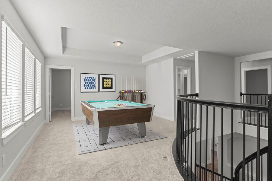 The upstairs game room offers endless possibilities! Bright and open with plush carpet flooring, this versatile area can be used for movie nights, hobbies, or as a relaxing retreat for family and friends. *Photo Staged*