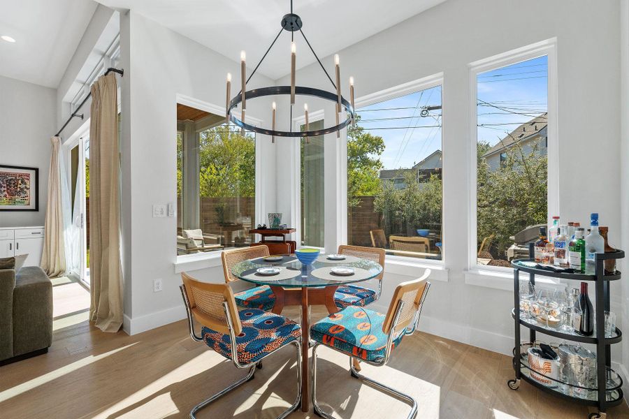 Dining room with wood finished floors and a chandelier