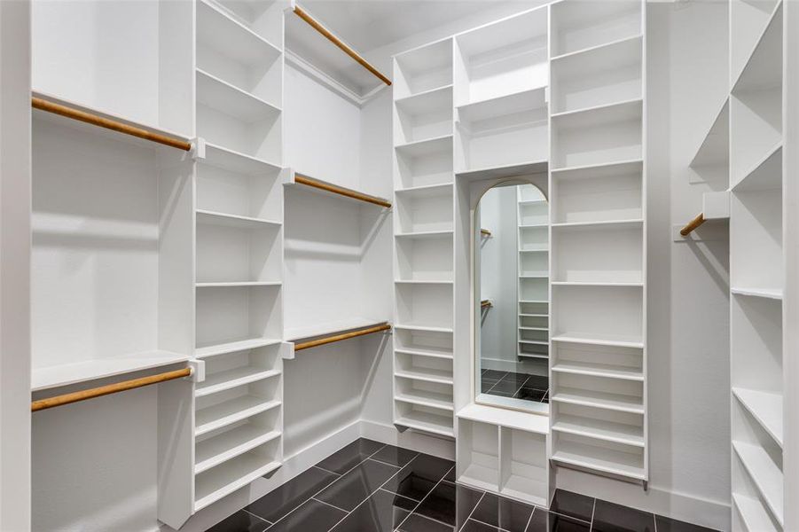 Walk in closet with dark tile patterned flooring