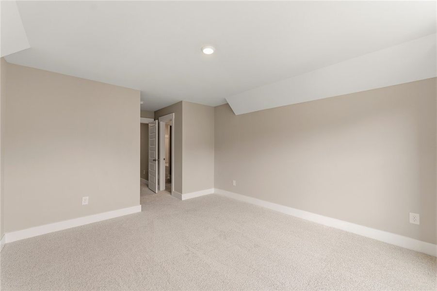 A spacious, naturally illuminated room featuring p