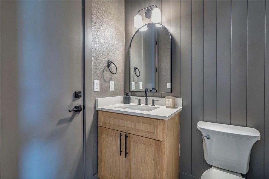 A well-appointed bathroom with natural wood cabinetry and a clean, modern aesthetic.
