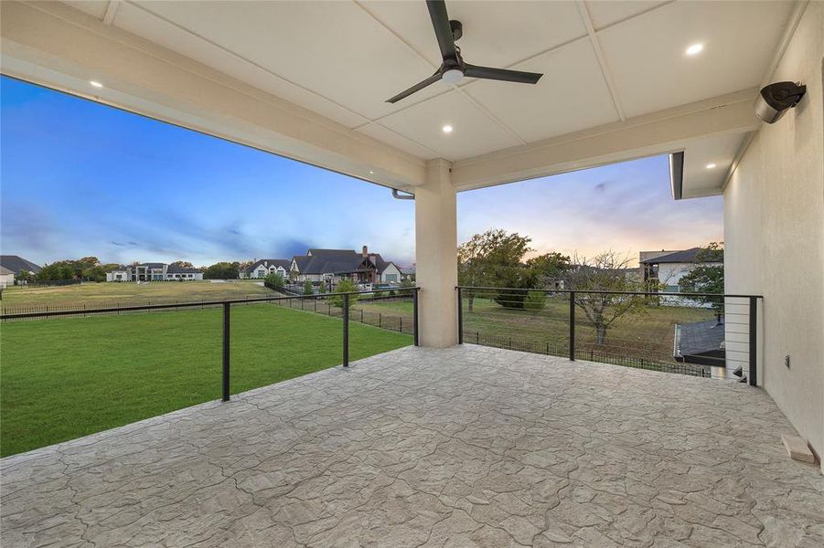View of patio with ceiling fan and a residential view