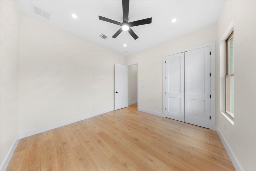Unfurnished bedroom with light wood-type flooring, recessed lighting, a ceiling fan, and a closet Unfurnished bedroom with light wood-type flooring, recessed lighting, a ceiling fan, and a closet