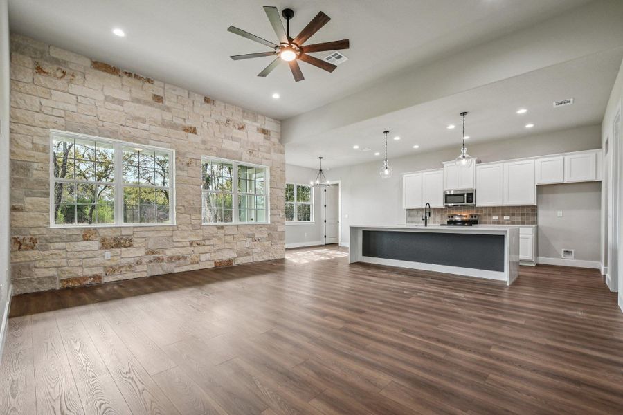 Unfurnished living room featuring dark wood-style flooring, recessed lighting, and a ceiling fan