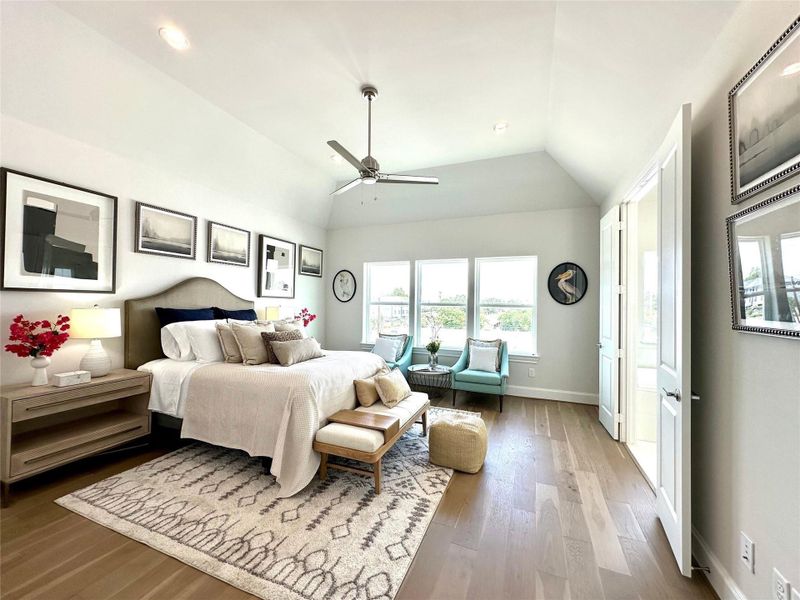 Wood floors throughout, including in the primary bedroom.