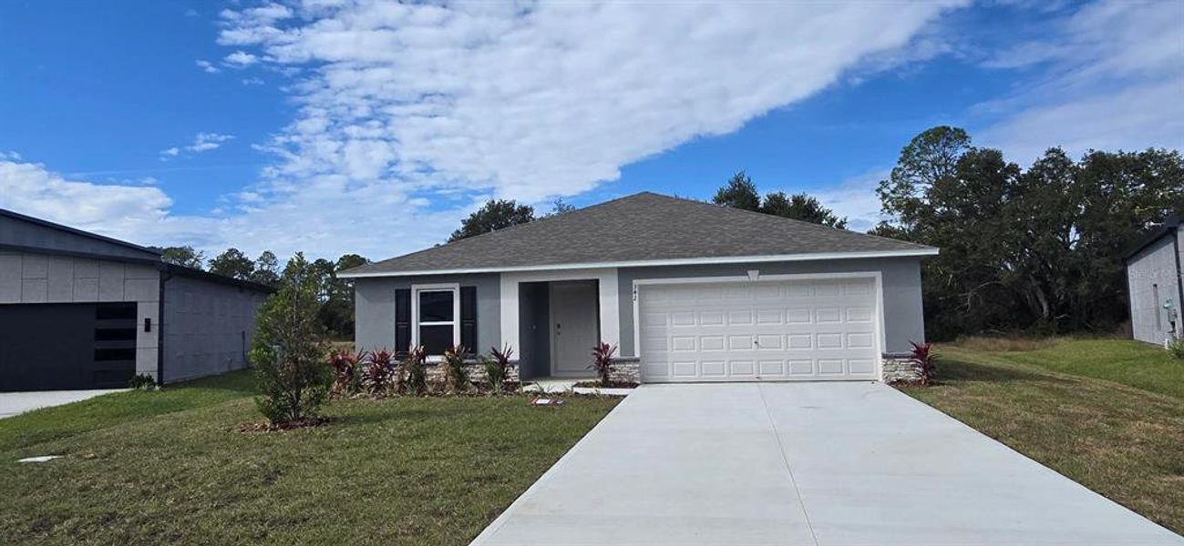 Front exterior of a new home in , Poinciana, FL, highlighting curb appeal (Image 2). Front exterior of a new home in , Poinciana, FL, highlighting curb appeal (Image 2).