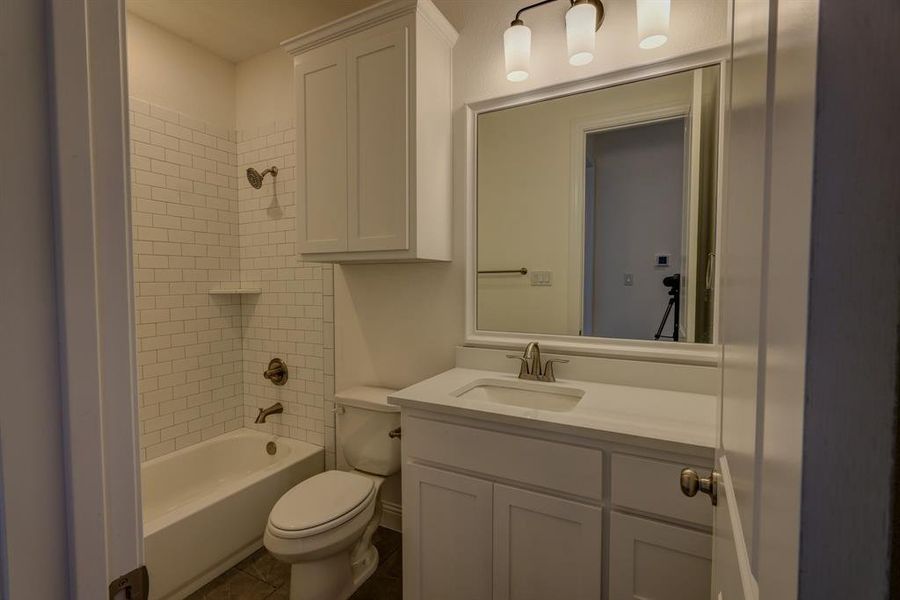 Bathroom with toilet, vanity, and shower / tub combination