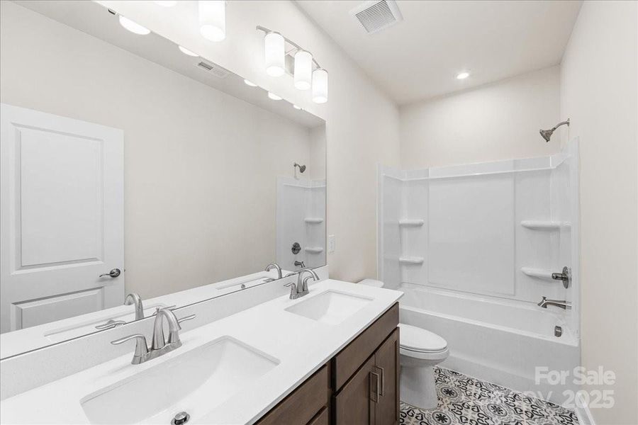 Secondary Bathroom with Dual Vanity and Modern Tile.