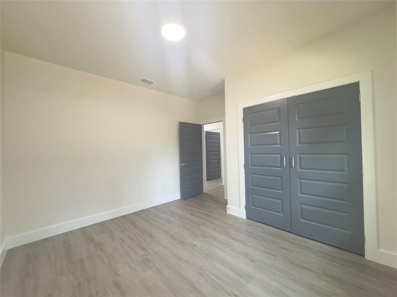 Unfurnished bedroom featuring a closet and light hardwood / wood-style flooring