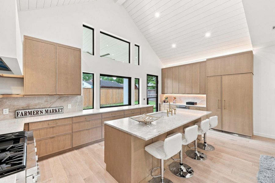 Kitchen with custom cabinets, Taj Mahal countertops, and Thermadore appliances.