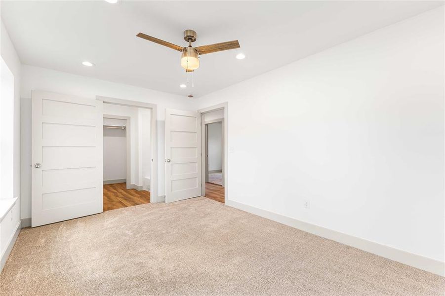 Unfurnished bedroom with carpet floors, recessed lighting, baseboards, ceiling fan, and a closet Unfurnished bedroom with carpet floors, recessed lighting, baseboards, ceiling fan, and a closet