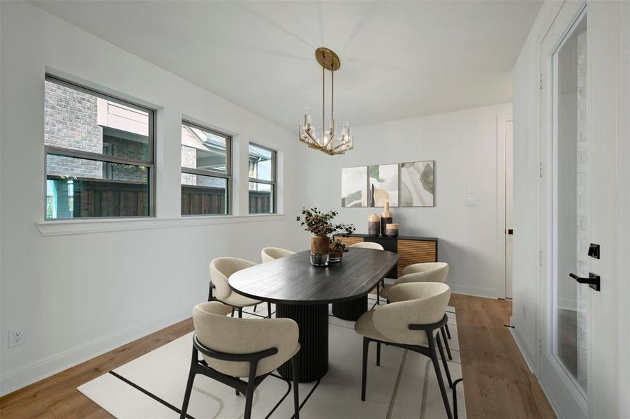 Dining space featuring light wood-style floors and suspended lighting