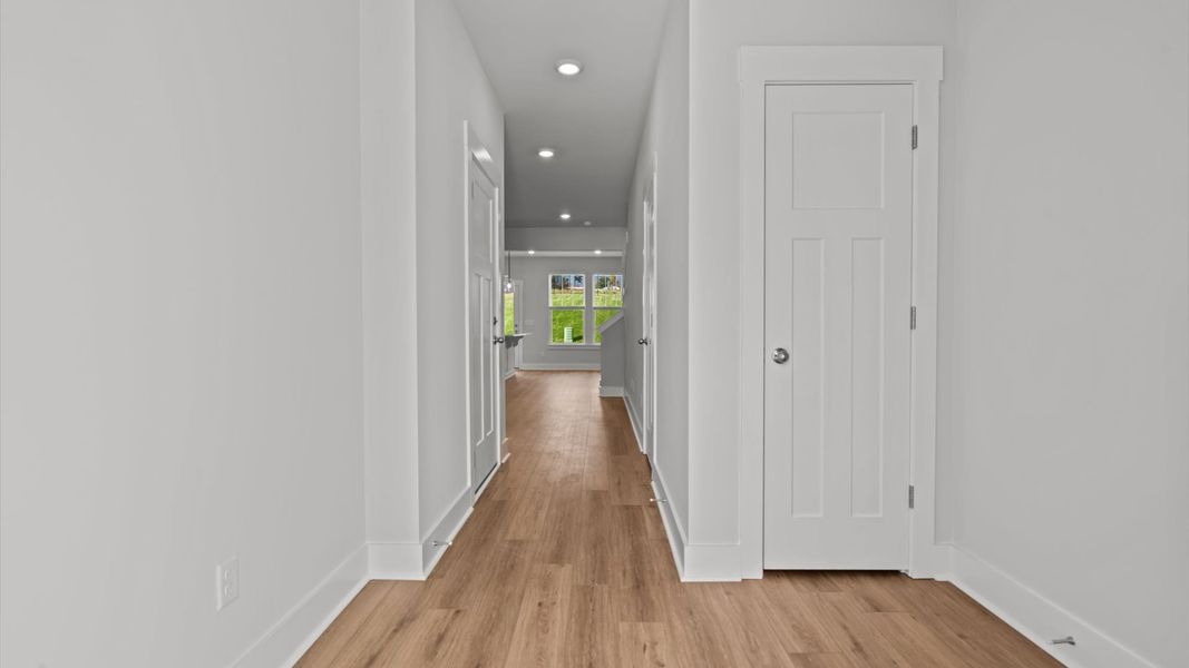 Eye-catching entry with hardwood flooring and a bright, inviting atmosphere Eye-catching entry with hardwood flooring and a bright, inviting atmosphere