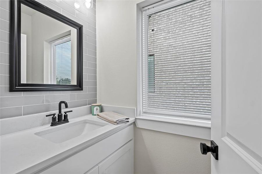 Bathroom with vanity and tasteful backsplash Bathroom with vanity and tasteful backsplash