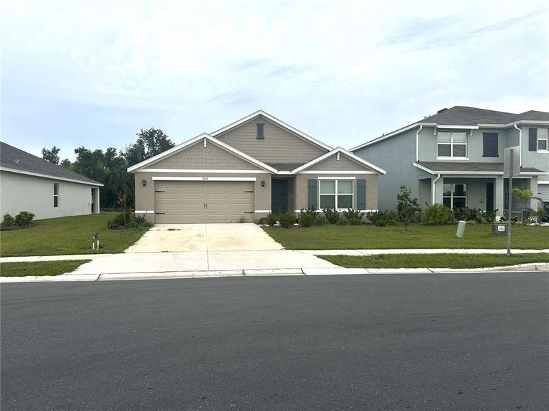 Front exterior of a new home in Silverstone North, Palmetto, FL, highlighting curb appeal (Image 26).