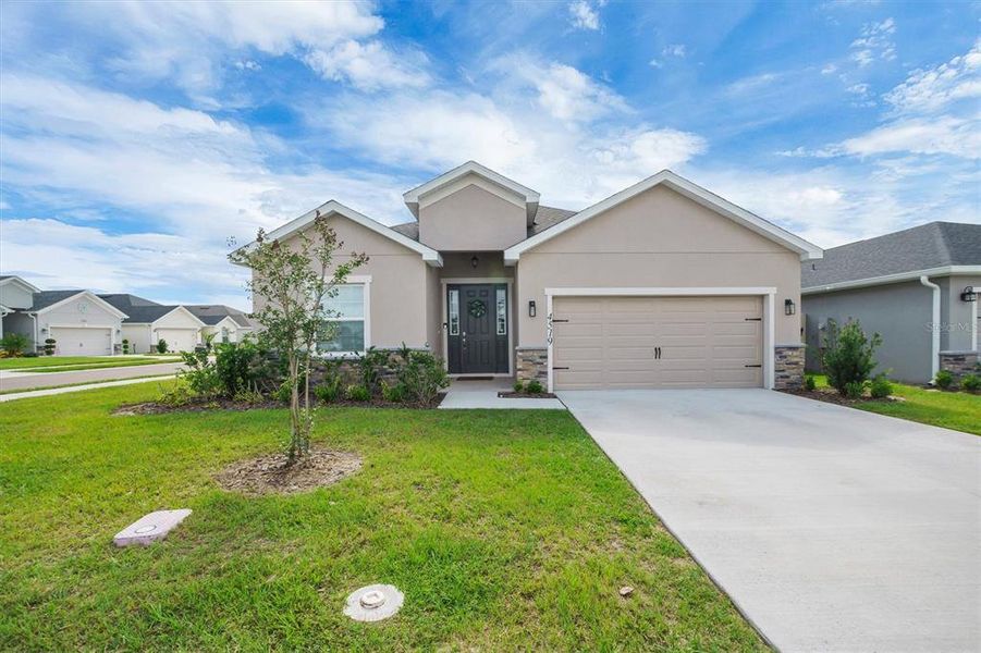 Front exterior of a new home in , Winter Haven, FL, highlighting curb appeal (Image 2). Front exterior of a new home in , Winter Haven, FL, highlighting curb appeal (Image 2).