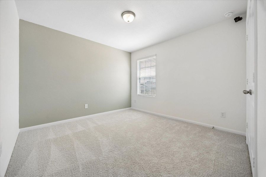 Unfurnished room with light carpet and baseboards