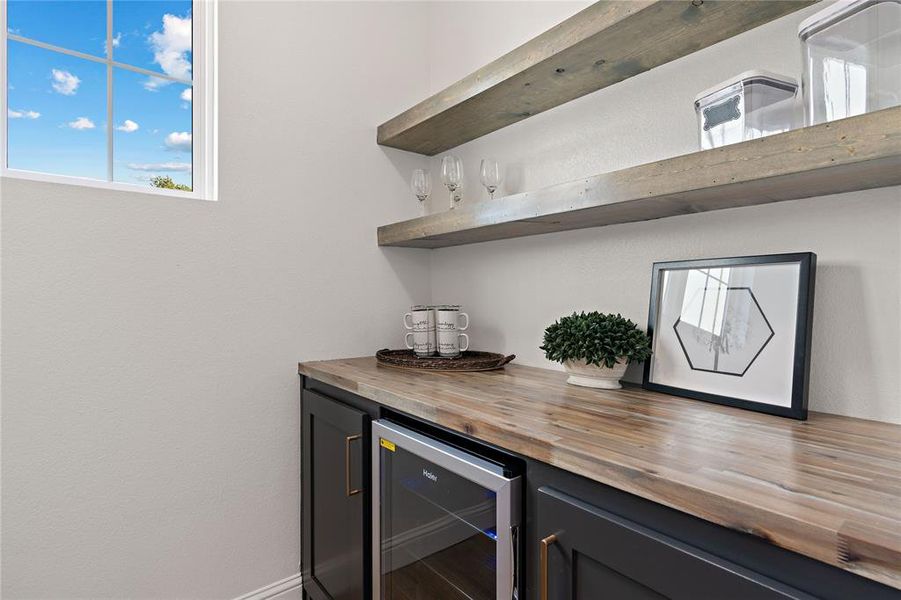 Bar with butcher block counters, wood-type flooring, and beverage cooler