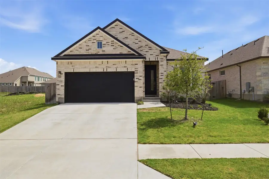 Front exterior of a new home in , Manor, TX, highlighting curb appeal (Image 26).