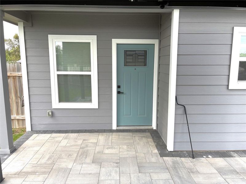 Backdoor entry with custom pavers.