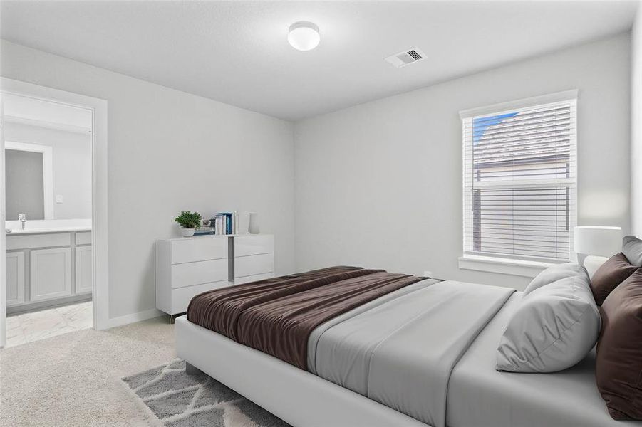 Secondary bedroom features plush carpet, neutral paint, large window with privacy blinds, and access to its own private secondary bathroom.