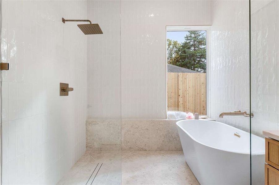 Full bathroom with walk in shower and a soaking tub