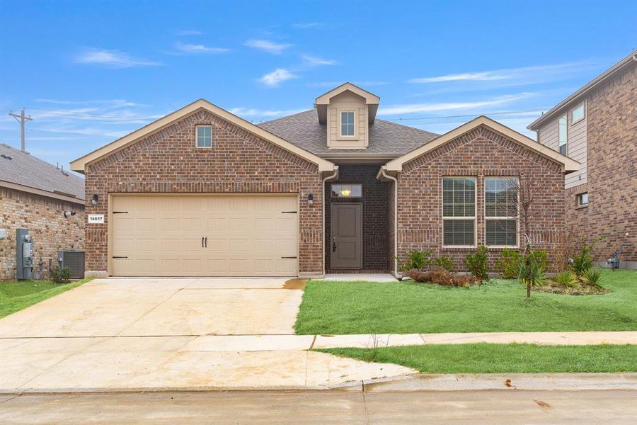 Front of property with central AC, a garage, and a front lawn