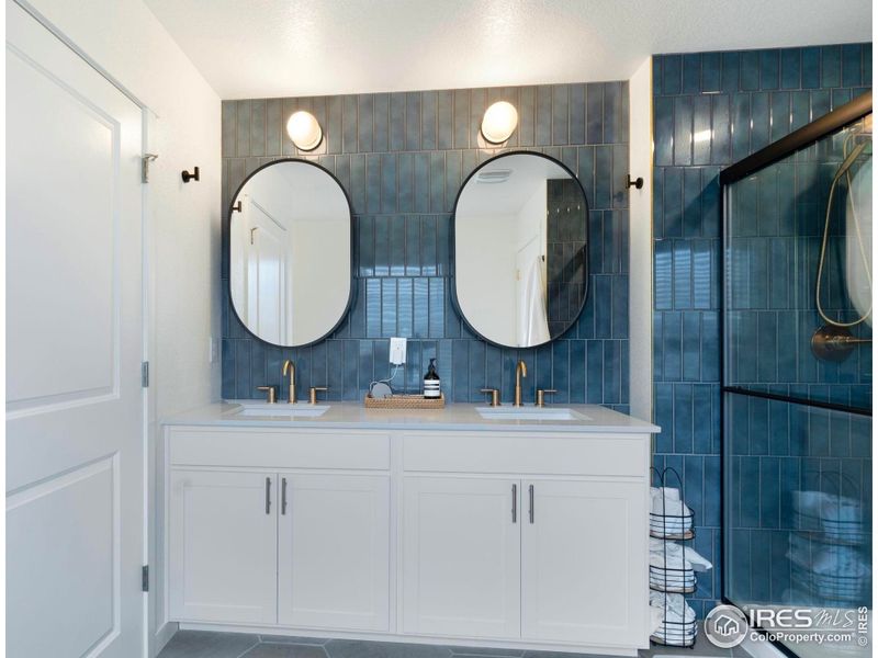 Large double vanity with custom tile and updated light fixtures. Large double vanity with custom tile and updated light fixtures.