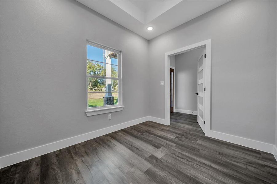 Empty room featuring dark hardwood / wood-style floors