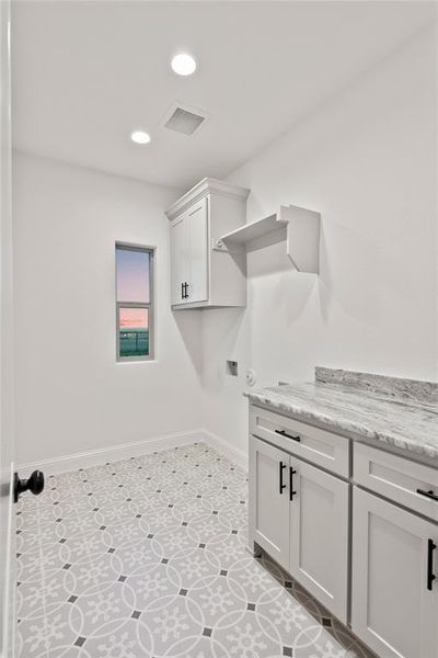 Laundry room featuring cabinet space, recessed lighting, and washer hookup