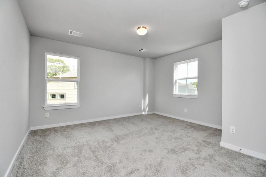 Secondary bedroom features plush carpeting, large windows that let in plenty of natural light, bright paint, and spacious closets. Secondary bedroom features plush carpeting, large windows that let in plenty of natural light, bright paint, and spacious closets.