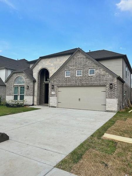 Front exterior of a new home in Morton Creek Ranch, Katy, TX, highlighting curb appeal (Image 1).