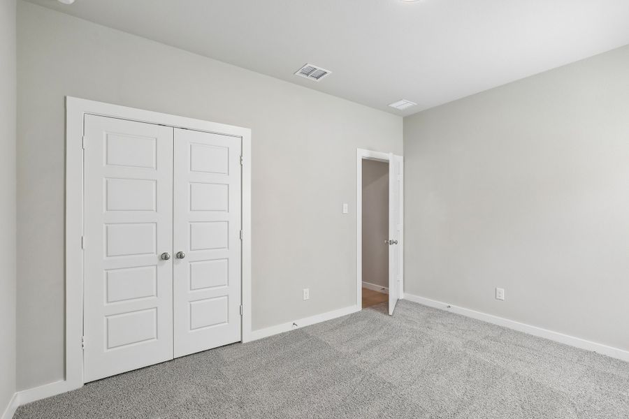 Bedroom in the Oscar home plan by Trophy Signature Homes