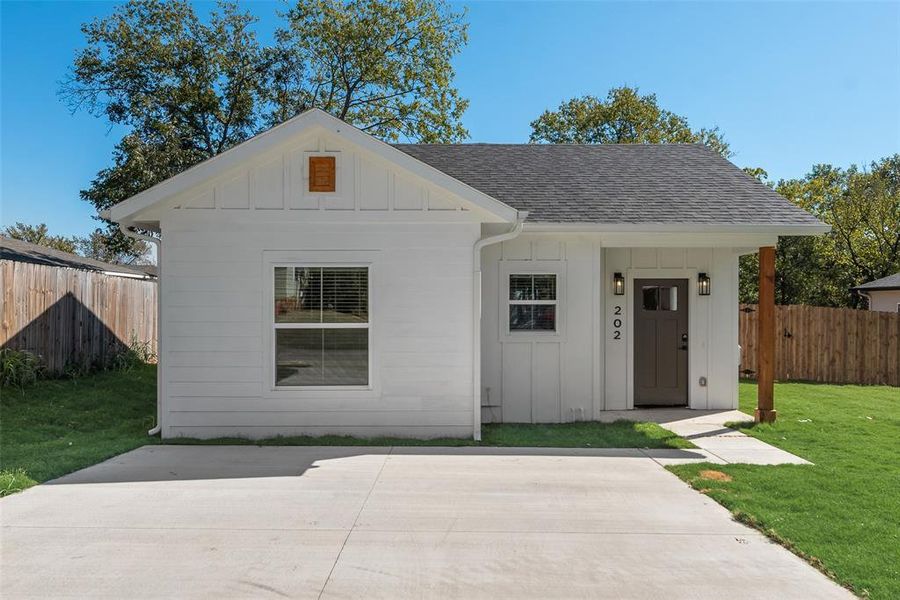 View of front facade with board and batten siding, a shingled roof, and an outdoor structure View of front facade with board and batten siding, a shingled roof, and an outdoor structure