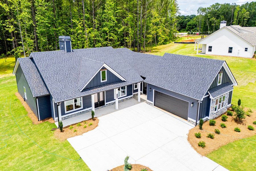 Front exterior of a new home in WOODMONT RESERVE, Roopville, GA, highlighting curb appeal (Image 31).