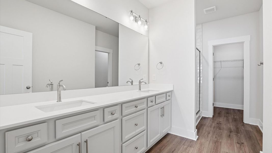 Exceptional en-suite with dual vanity and glass-enclosed walk-in shower for superior everyday comfort Exceptional en-suite with dual vanity and glass-enclosed walk-in shower for superior everyday comfort