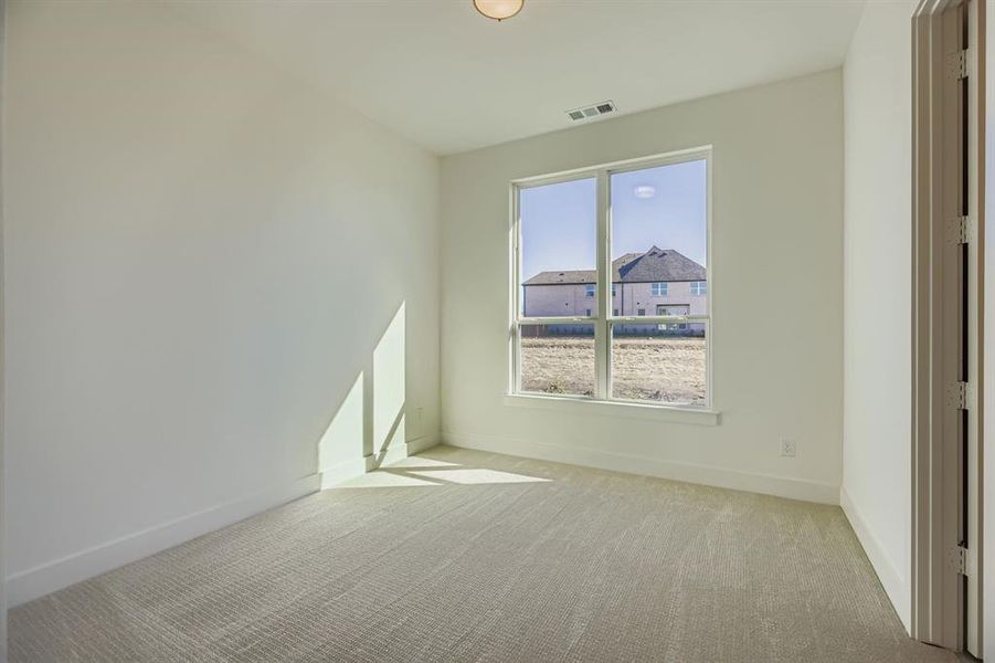 Empty room featuring light carpet and baseboards Empty room featuring light carpet and baseboards