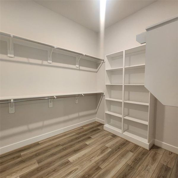 large walking closet with built in shelves