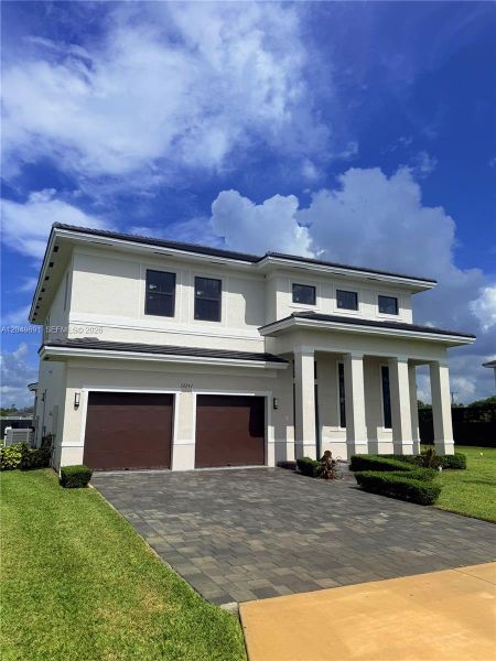 Front exterior of a new home in , Homestead, FL, highlighting curb appeal (Image 2). Front exterior of a new home in , Homestead, FL, highlighting curb appeal (Image 2).