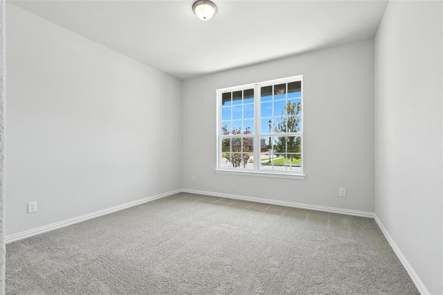 Unfurnished room with light colored carpet and baseboards