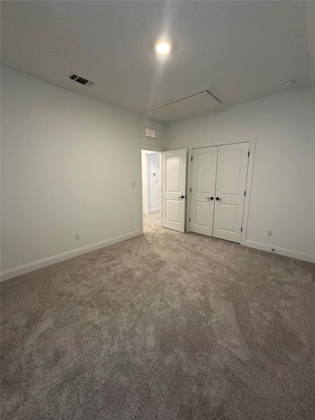 Spacious room featuring plush carpeting, white baseboards, and light neutral wall paint Spacious room featuring plush carpeting, white baseboards, and light neutral wall paint