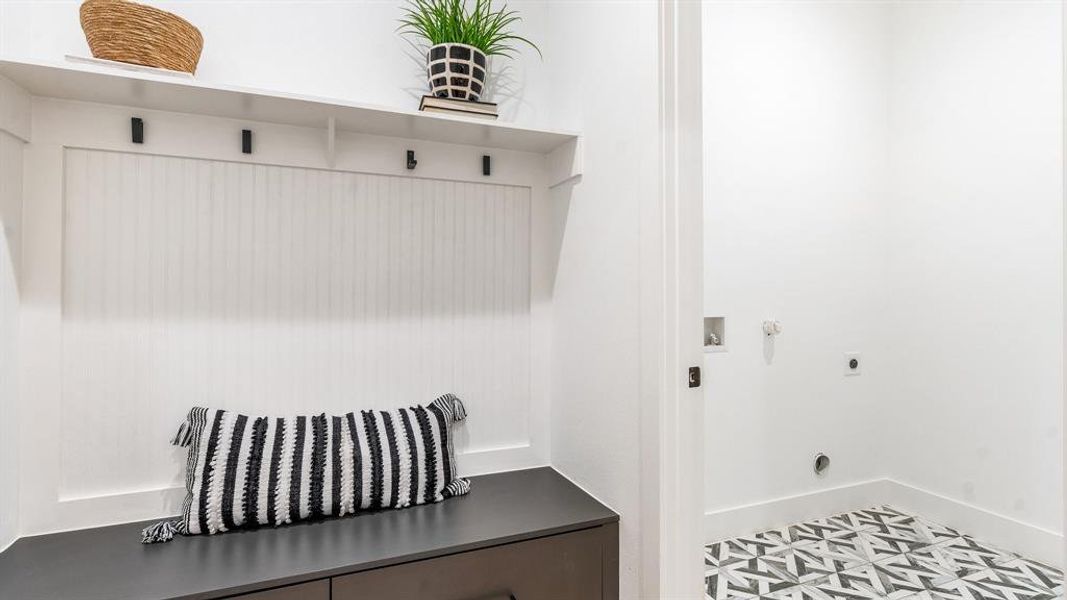 Mudroom featuring tile floors