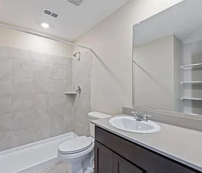 Bathroom featuring vanity, a stall shower, and recessed lighting