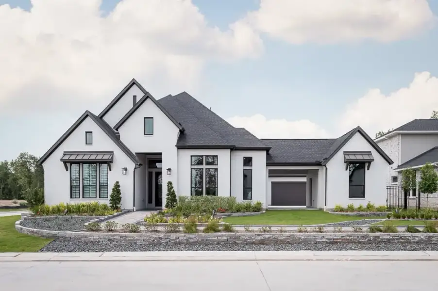 Front exterior of a new home in Legacy Grove, Montgomery, TX, highlighting curb appeal (Image 1). Front exterior of a new home in Legacy Grove, Montgomery, TX, highlighting curb appeal (Image 1).