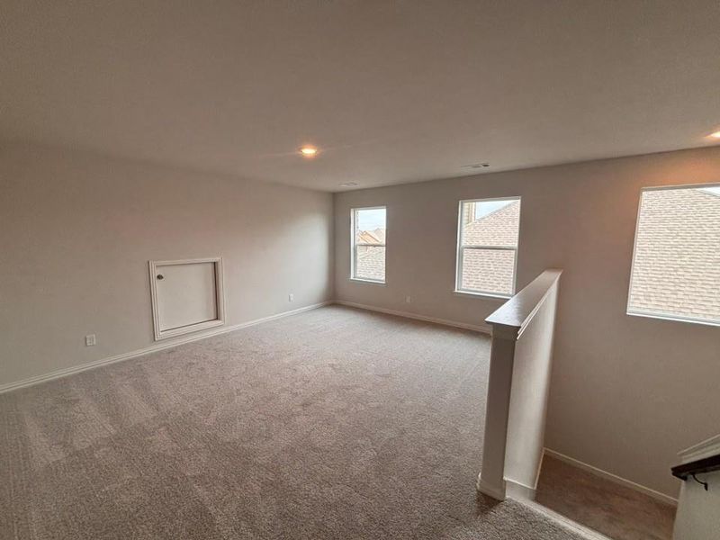 Carpeted empty room with baseboards and recessed lighting Carpeted empty room with baseboards and recessed lighting